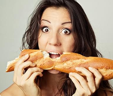 Woman eating bread